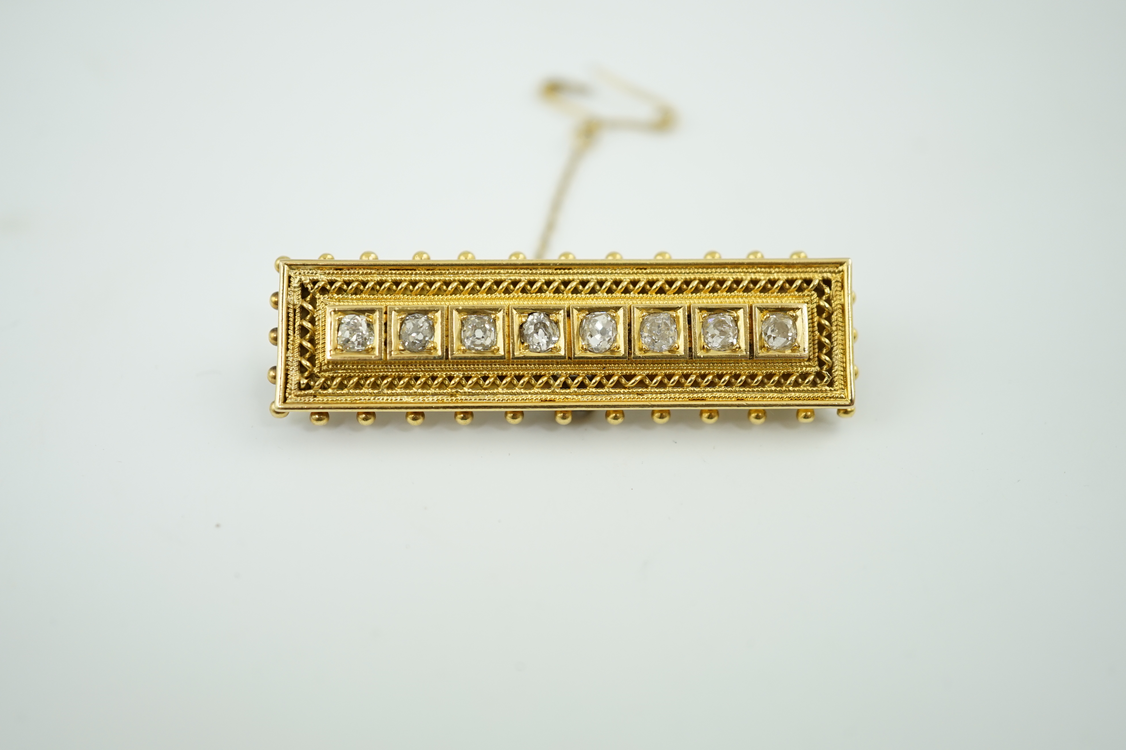 A late Victorian gold and eight stone diamond set brooch, of rectangular form, with beaded border, 46mm, gross weight 9.1 grams. Condition - fair